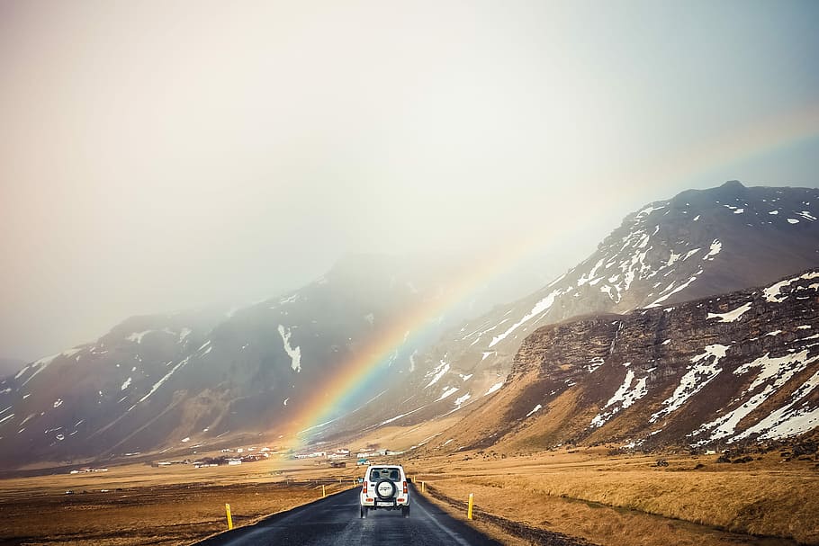 HD wallpaper: white car travelling near mountains with rainbow ...
