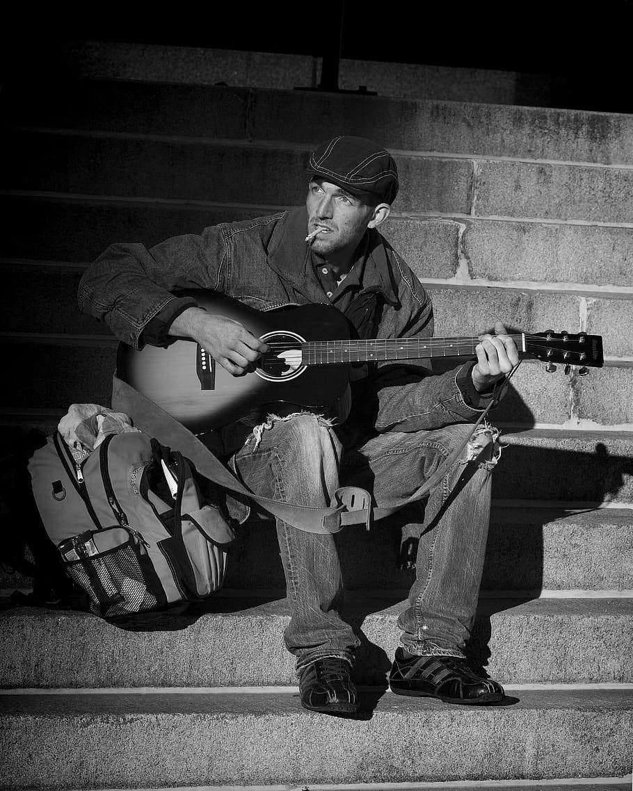 man in black denim jacket playing guitar, people, homeless, musician