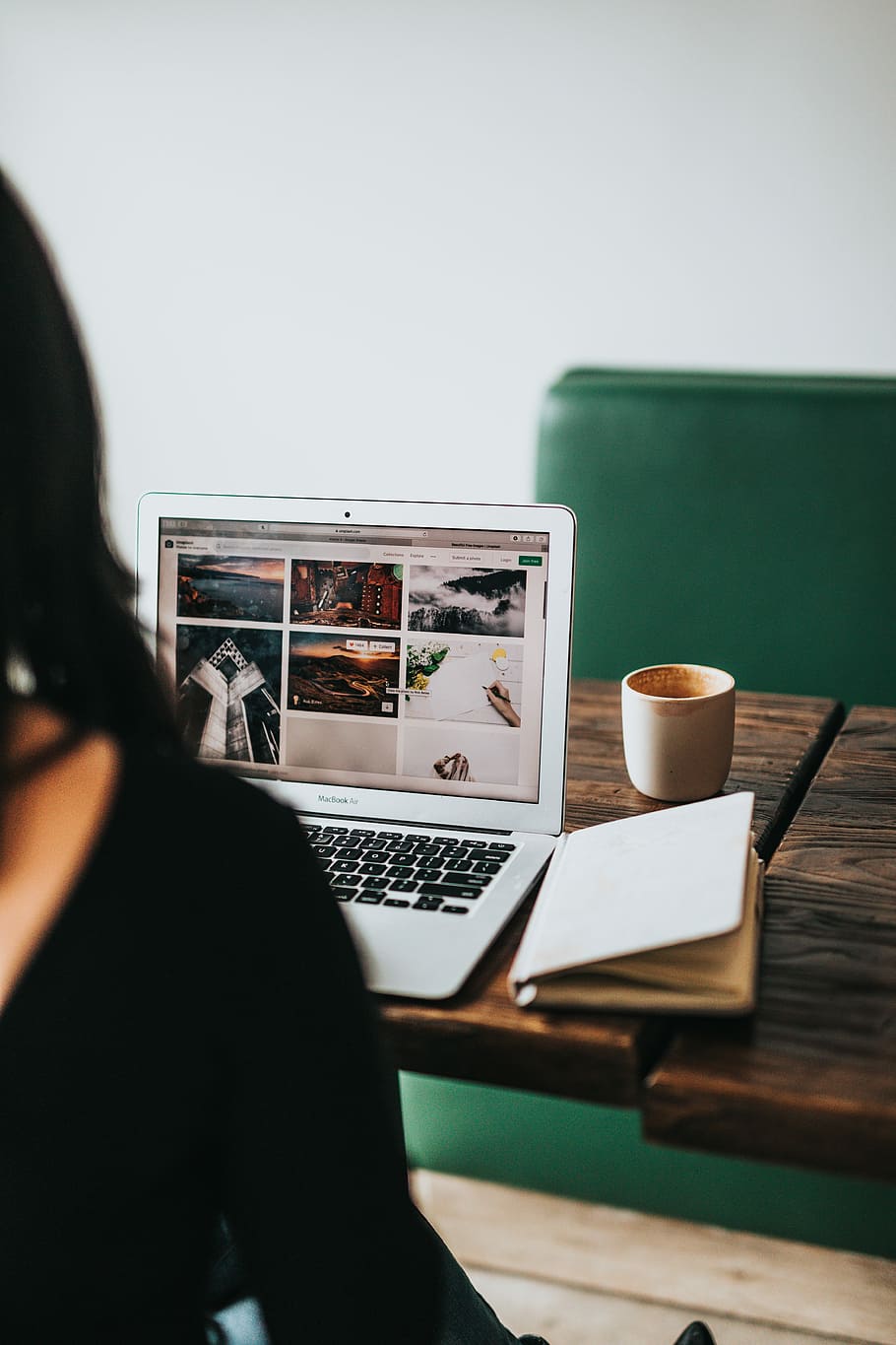 MacBook Air on table, woman looking pictures in her laptop, working HD wallpaper