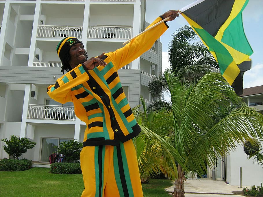 Man holding Jamaican Celebration Flag, photos, public domain, HD wallpaper