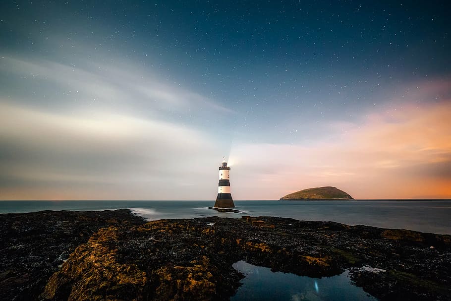 photo of white and brown lighthouse, remote, sky, clouds, sunset HD wallpaper