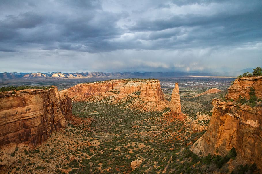photo of brown rock formation under white and blue sky at daytime HD wallpaper