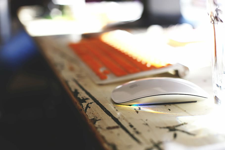selective focus photography of Apple Magic Mouse on desk, brown HD wallpaper