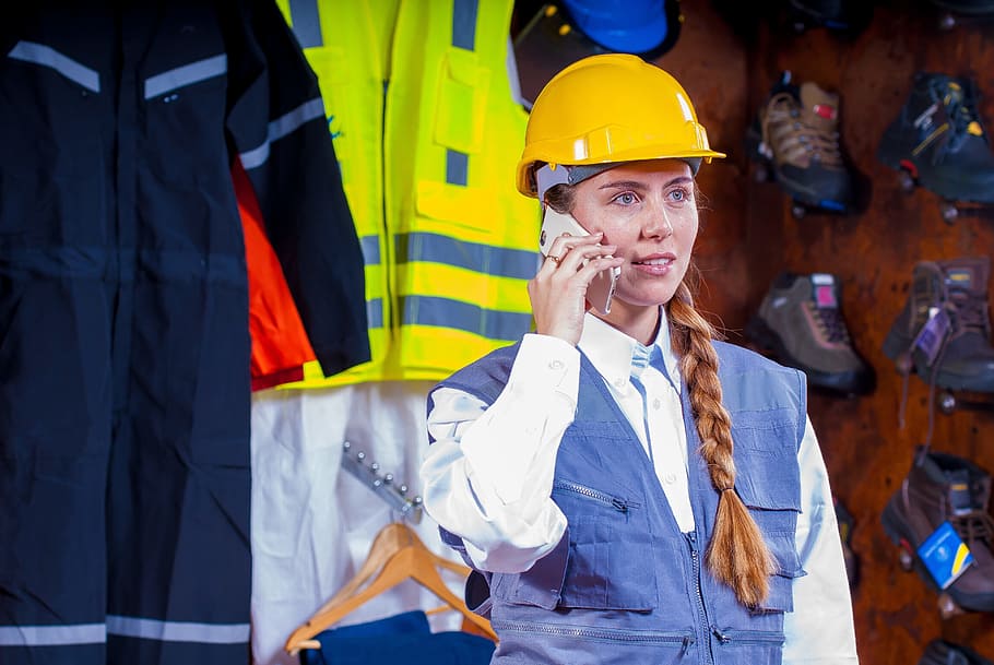 woman in white button up shirt holding smartphone, helmet, industrial HD wallpaper