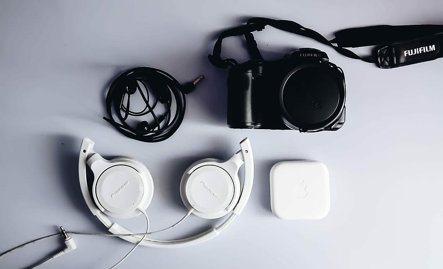 black Fujifilm DSLR camera and white corded headphones, white corded headphones near black camera HD wallpaper