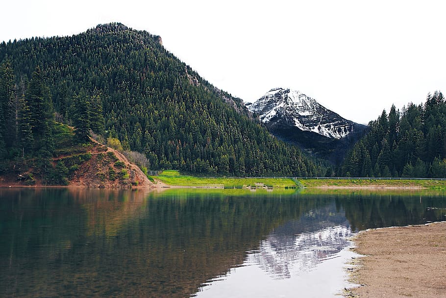 photo of mountain near river at daytime, body of water distance with trees and mountain during daytime HD wallpaper