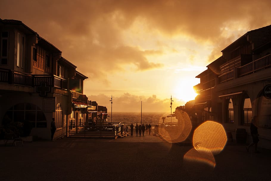 sea, city, dawn, sky, building, clouds, dusk, silhouette, street HD wallpaper