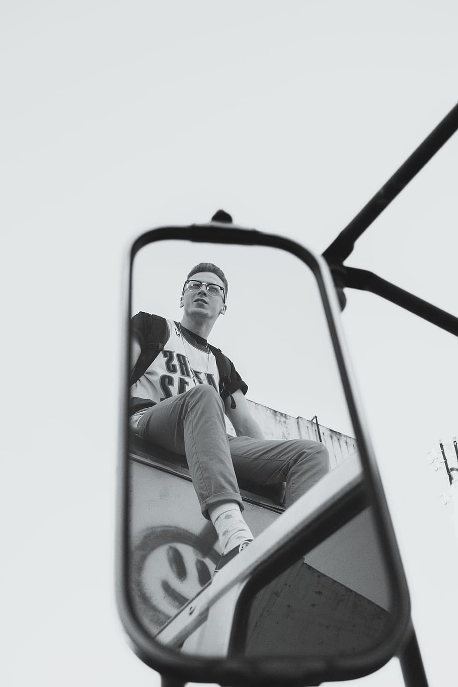 grayscaled photo of reflection of man in side mirror, reflection of man from a mirror sitting on compartment of truck HD wallpaper