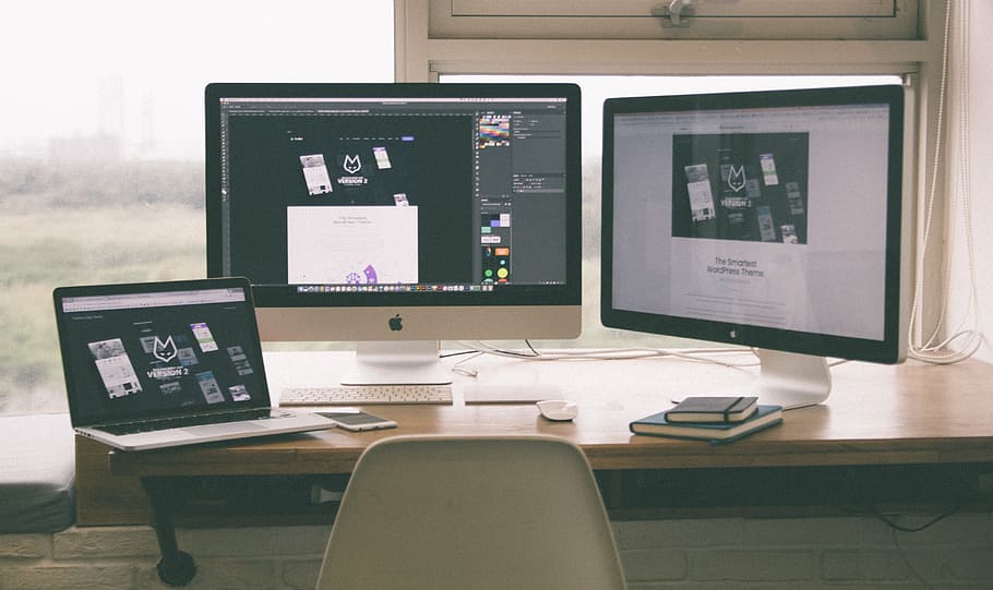 turned on Apple computer monitors on brown wooden table, laptop HD wallpaper