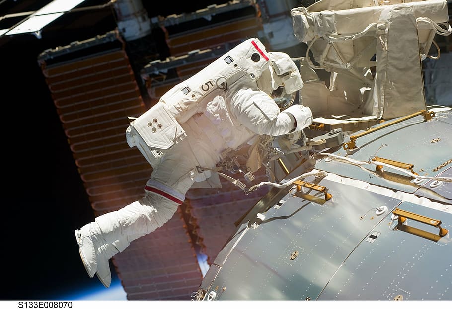 astronaut in space photo, spacewalk, iss, tools, suit, pack, tether