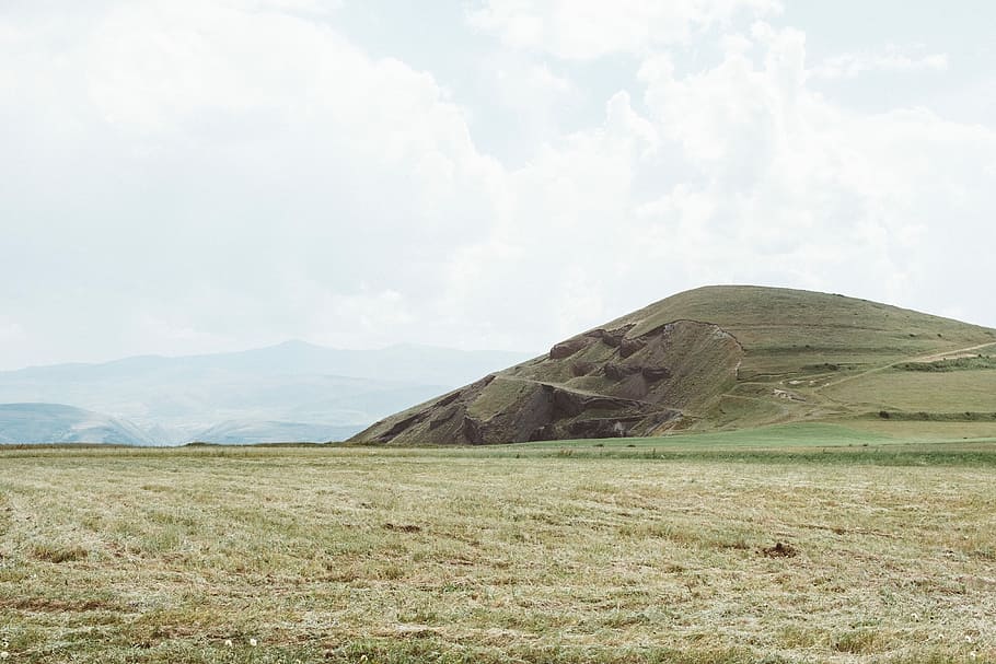 landscape photography of hill, landscape photo of grass filled ground near mountain HD wallpaper