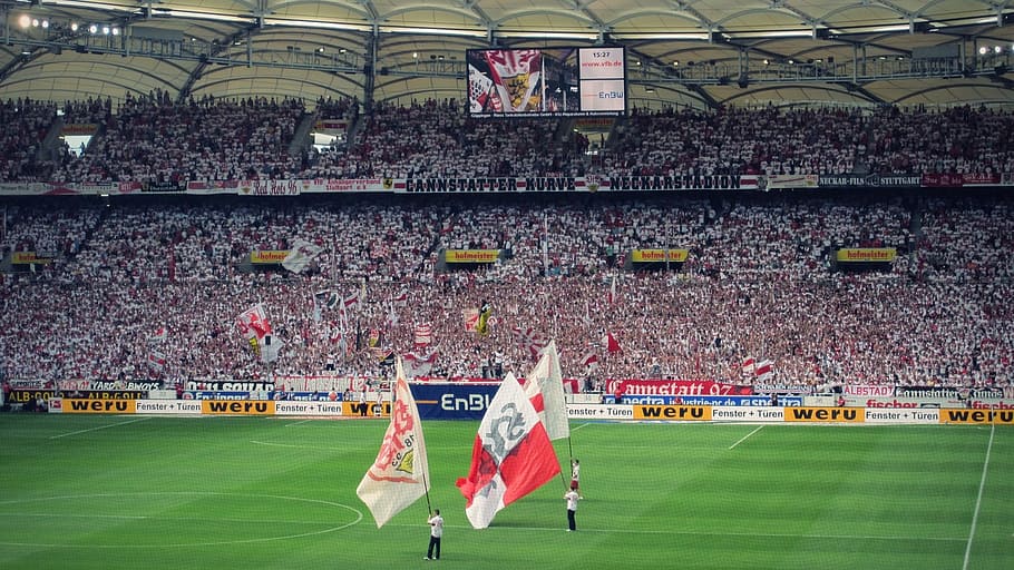 three man holding flags in middle of stadium, vfb, stuttgart