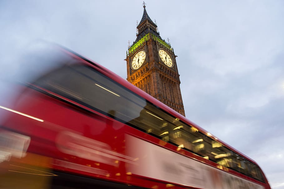 Time goes back, time-lapse photography of bus beside The Elizabeth Tower in London HD wallpaper