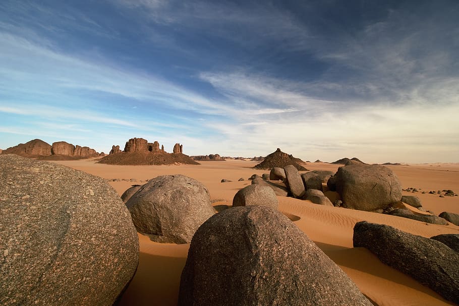 gray rock formations in a middle of desert, algeria, tassili n'ajjer