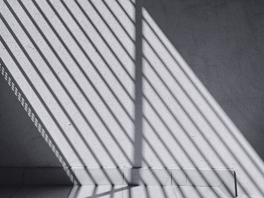 shadow of rail casting on gray wall, light, sunlight, window
