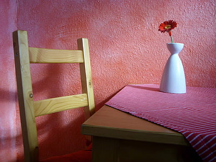 brown wooden table near chair with red daisy on white ceramic vase HD wallpaper