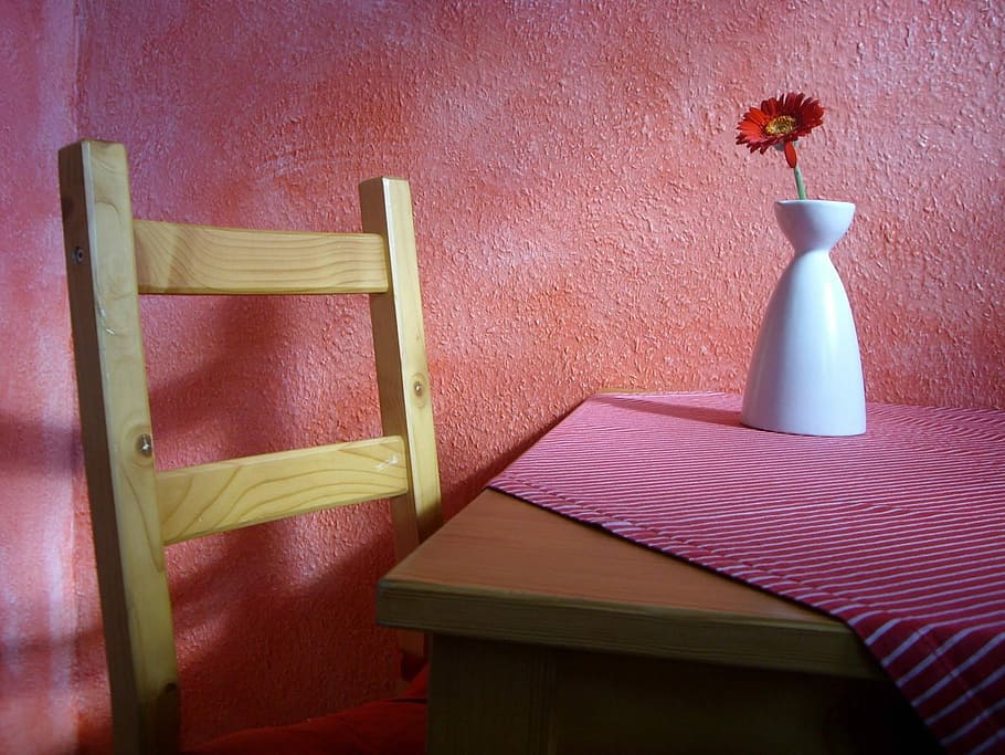brown wooden table near chair with red daisy on white ceramic vase HD wallpaper