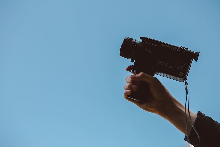 person holding video camera, person holding camcorder, Super 8