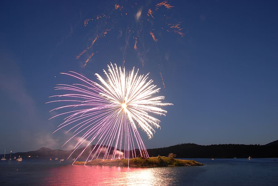 time lapse photography of fireworks above island, celebration HD wallpaper