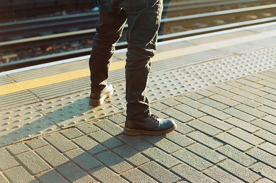 person wearing pair of black work boots standing on concrete blocks, person standing on concrete floor HD wallpaper