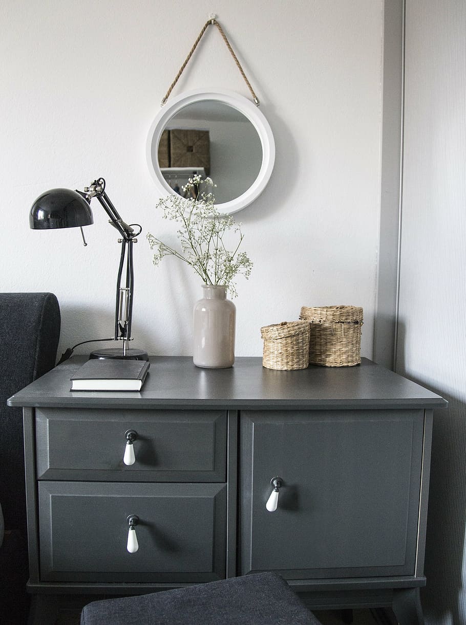 black gooseneck table lamp on gray wooden drawer, home, room