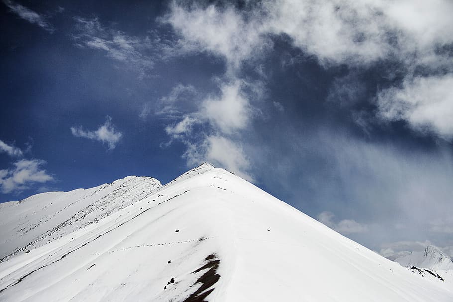 selective focus photography of mountain covered snow, snow mountain under white clouds HD wallpaper