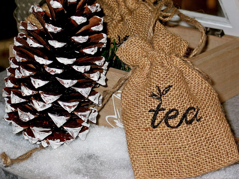 pine cone beside tea-printed bags, tee, tea time, contemplation, HD wallpaper
