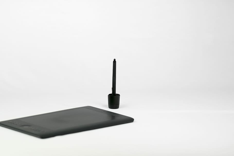 black stylus, graphics tablet beside pen, pencil, brush, art