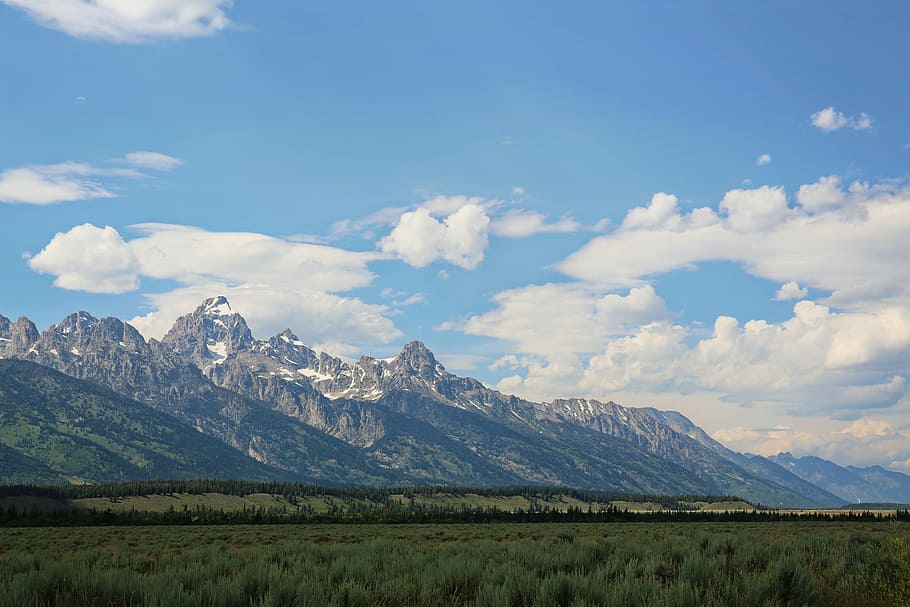 gray rocky mountains under white cloudy sky during daytime, mountain range during daytime HD wallpaper