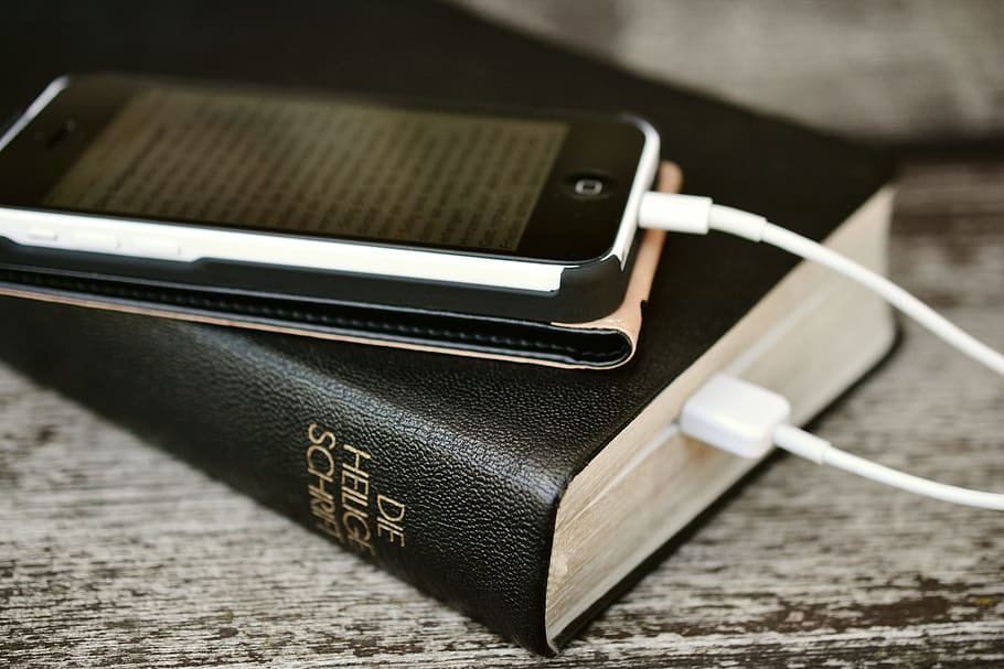 black iPod touch with black case, bible, iphone, mobile phone