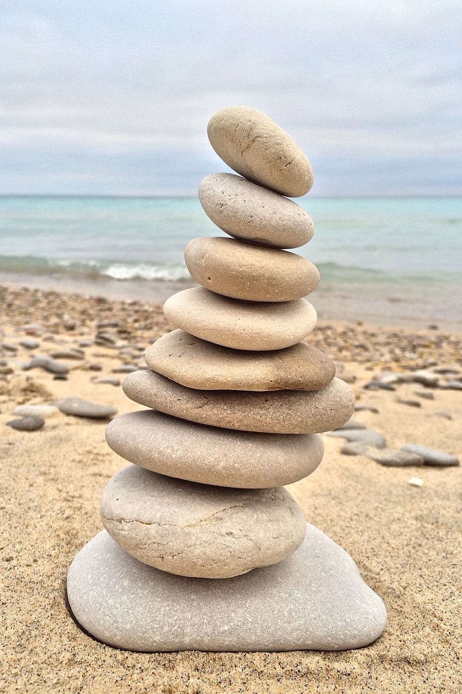 brown rock formation near body of water during daytime, stacking HD wallpaper