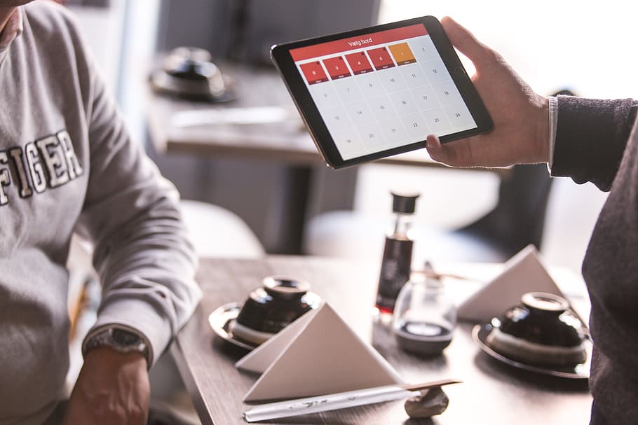 person holding opened space gray iPad, person holding black tablet computer HD wallpaper