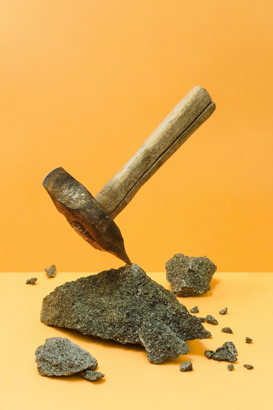 brown wooden handled mallet on stone near yellow wal, pick HD wallpaper
