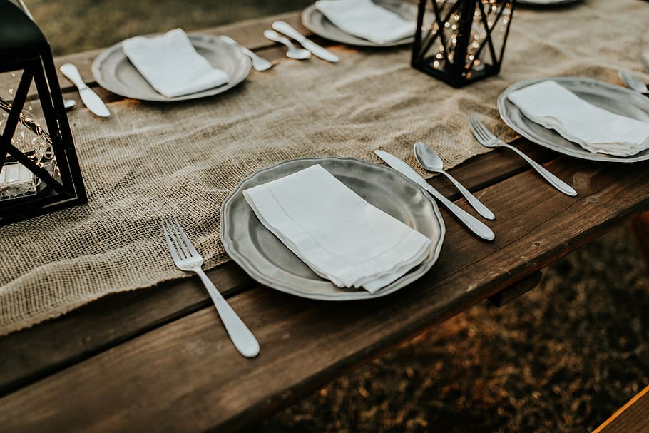 stainless steel plates, white paper towel on gray plate with gray cutlery set beside HD wallpaper