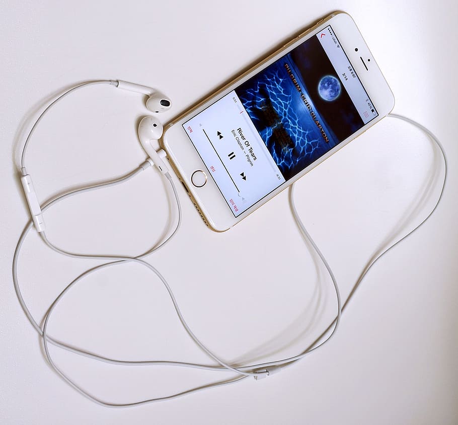 turned-on iPhone displaying music on white surface, iphone6plus