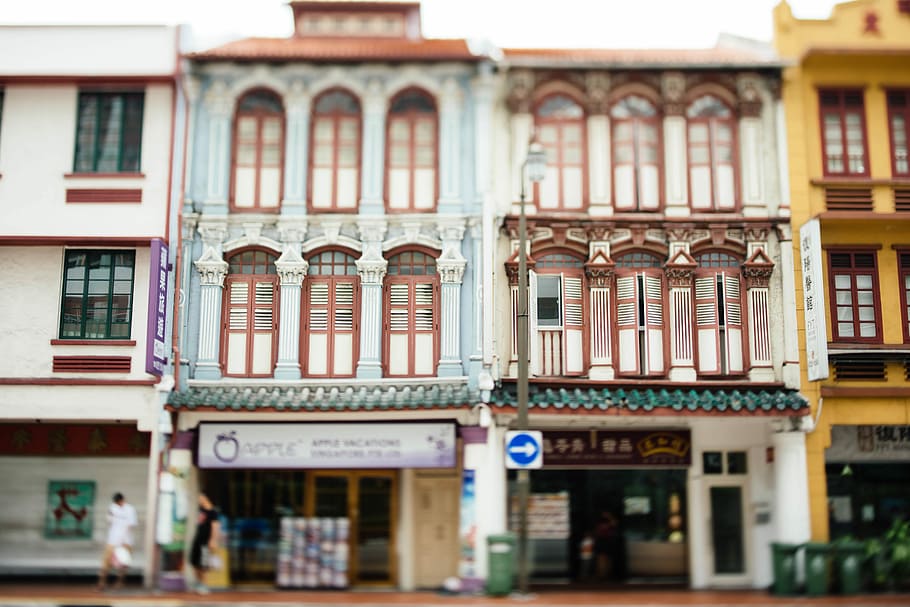 white and brown concrete building, low-angle photography of white concrete building