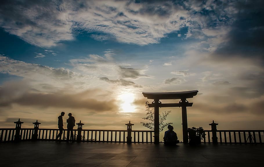 two person standing near railings under cloudy sky, pagoda, viet nam