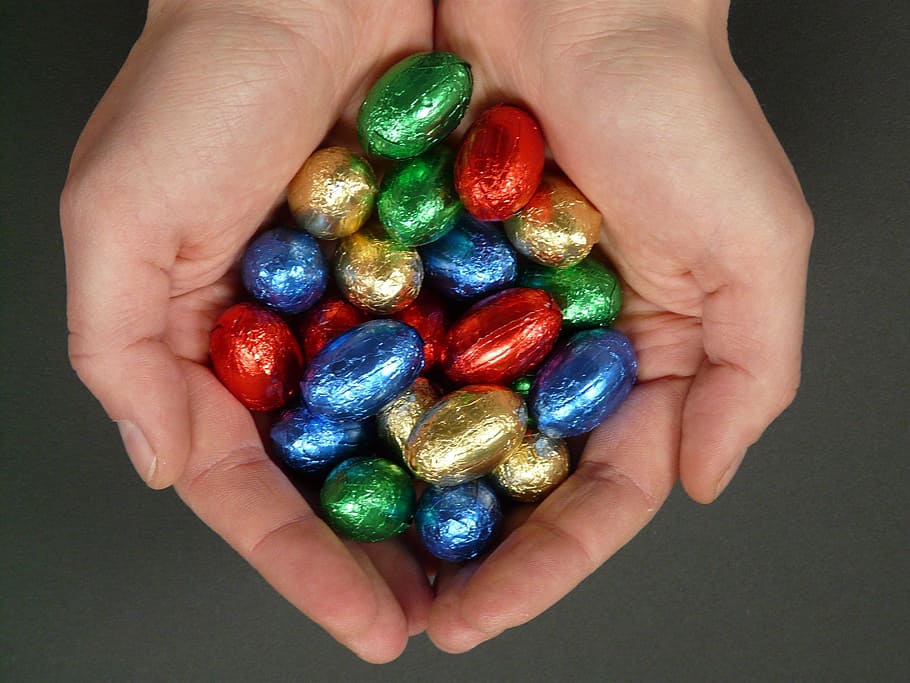 chocolates in person's palm, easter eggs, sweetness, nibble HD wallpaper