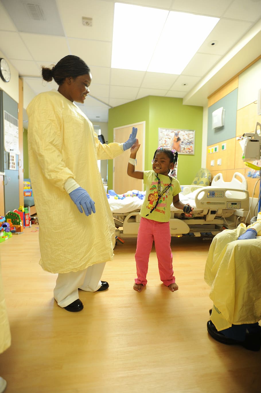 woman clapping to girl, hospital, nurse, patient, child, room