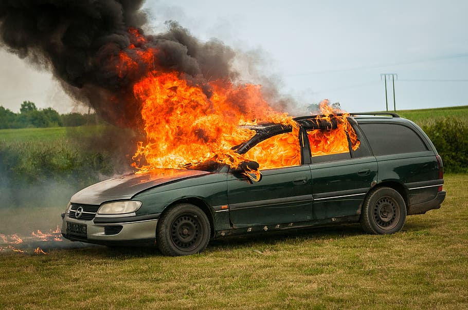 green station wagon burning on green grass field during daytime HD wallpaper