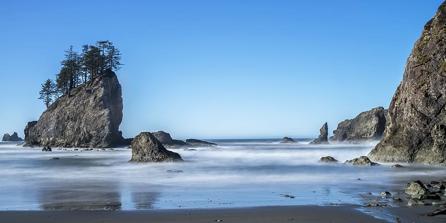 gray stones in sea at daytime, beach, pacific coastline, ocean