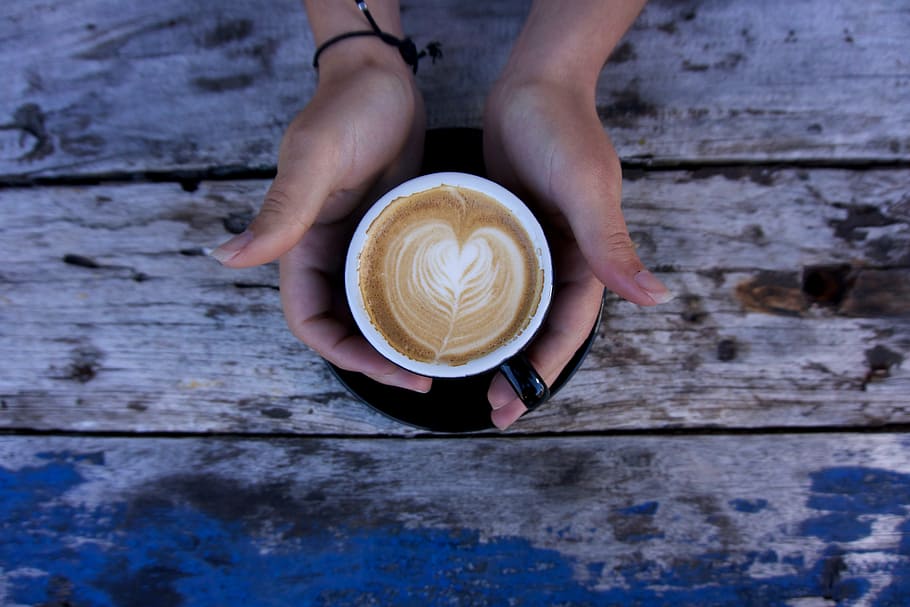 person holding latte on black ceramic cup, hands, coffee, table HD wallpaper