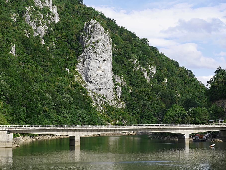 landscape photo of bridge and mountain range during daytime, relief