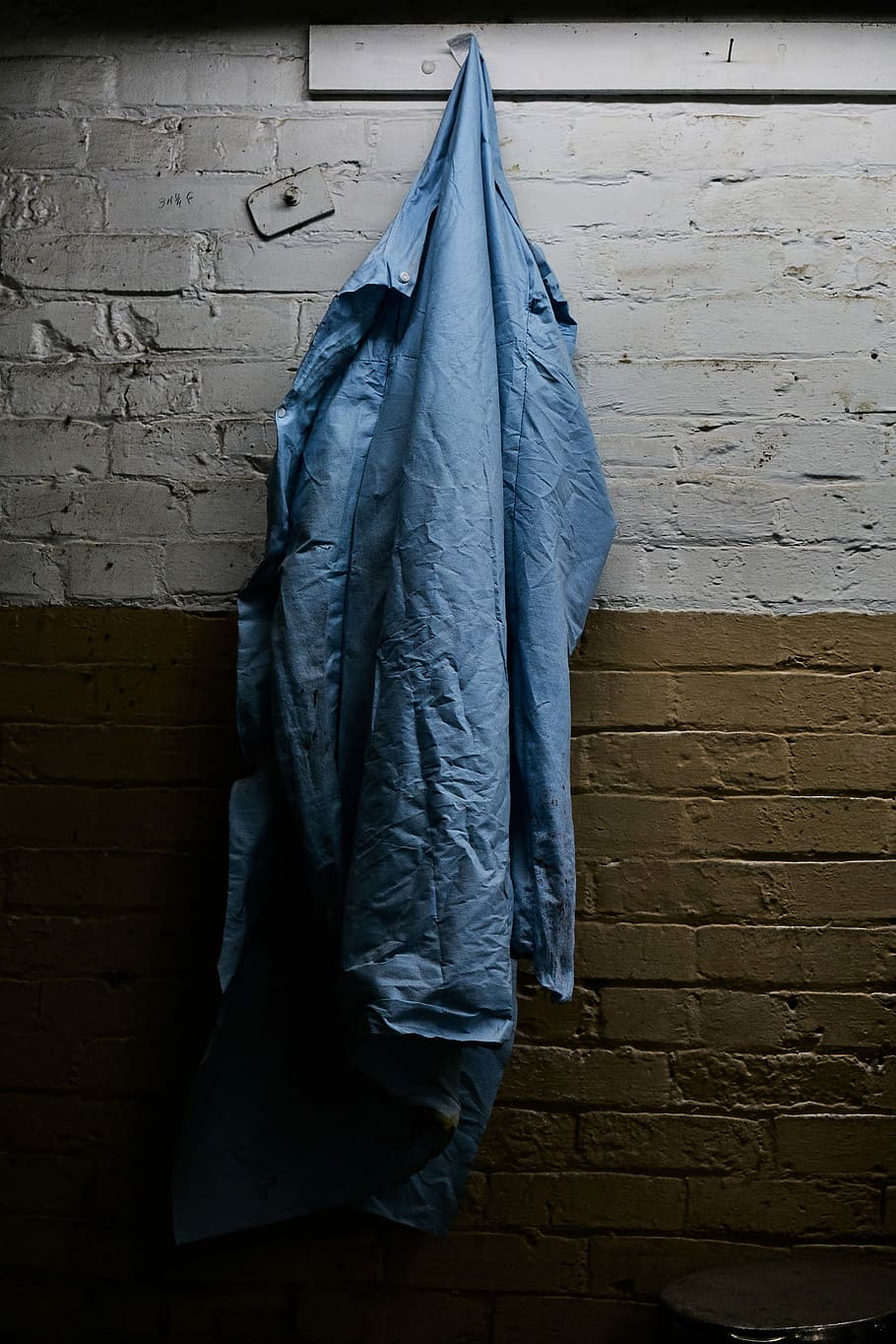 blue windbreaker hanging on hook, blue apparel hanging on grey and brown wall inside room, HD wallpaper