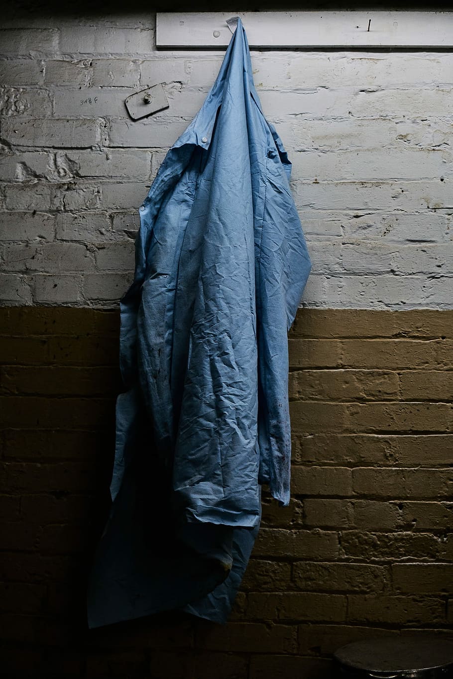 blue windbreaker hanging on hook, blue apparel hanging on grey and brown wall inside room HD wallpaper
