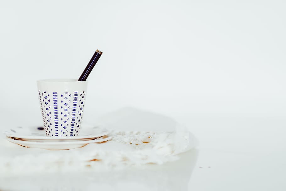 white cup with pen on white panel, teacup on saucer, ceramic HD wallpaper