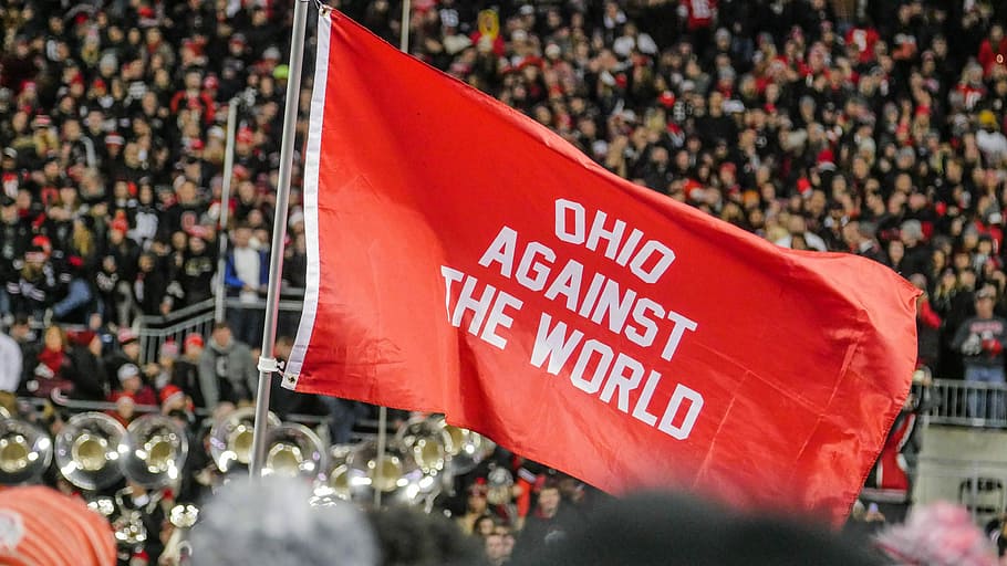 Ohio Against The World flag, shallow focus photography of red flag with Ohio against the world printed, HD wallpaper