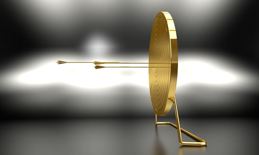 selective focus photography of round gold stand decor, arrow