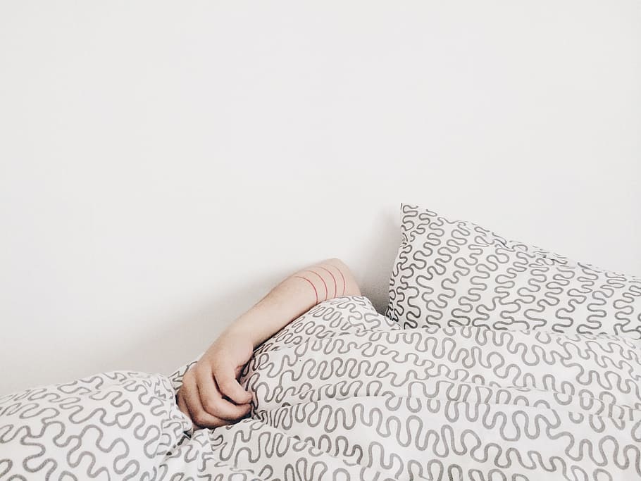 person covering his body with comforter, hand, bed, pillow HD wallpaper