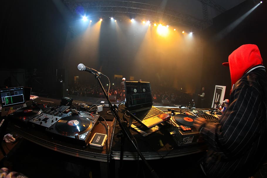 person near DJ controller, concert, scene, music, rap, hip hop